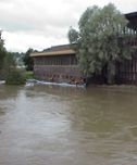 Räddningstjänsten placerar ut provisoriska vallar för att skydda Sporthallsbadet från den översvämmade ån